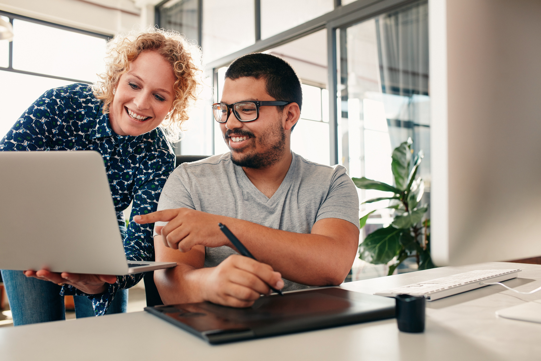 Commission partners reviewing a laptop
